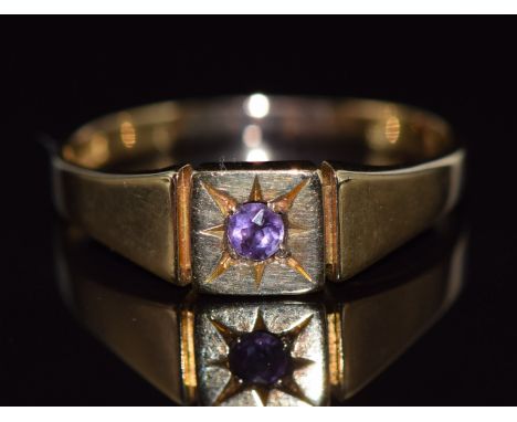 An 18ct gold ring set with an amethyst in a star setting, 4.1g, size T