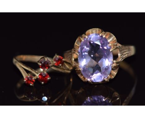 A 9ct gold ring set with an oval cut amethyst and a 9ct gold ring set with garnets, 5.4g, sizes K and X