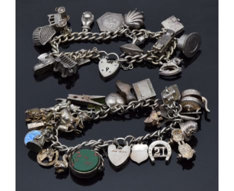 Two silver charm bracelets with over 29 charms including enamel clover, St Christopher, shell, circus, car, etc (133.5g)&nbsp