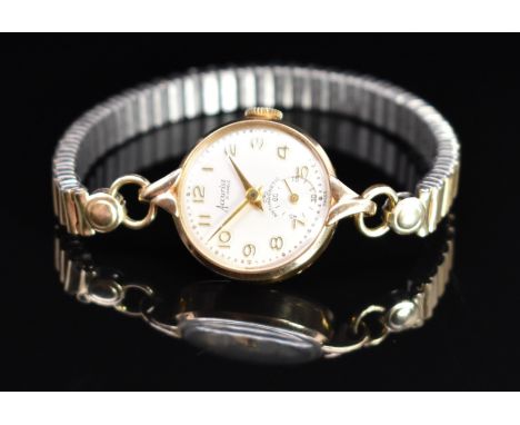 Accurist 9ct gold ladies wristwatch with inset subsidiary seconds dial, gold hands and Arabic numerals, silver dial and signe