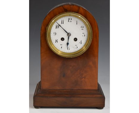 A c1900 mahogany carved arch top mantel clock, the anonymous two train movement stamped 3000, 52, striking on a gong, Arabic 