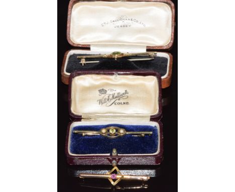 A 15ct gold brooch set with peridot (3.1g), 15ct gold brooch set with peridot and pearls (3.1g) and a 9ct gold brooch set wit