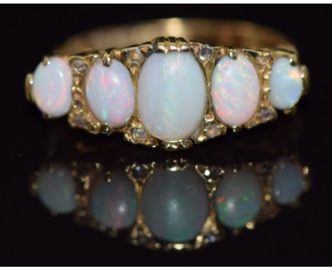 An 18ct gold ring set with five opal cabochons and rose cut diamonds, Birmingham 1903, 6.2g,&nbsp;size Q&nbsp;