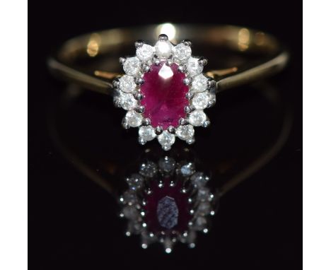 A 9ct gold ring set with an oval cut ruby and diamonds, 2.2g,&nbsp;size Q