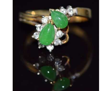 A 14k gold ring set with two pear cut jade cabochons and diamonds, 3.2g, size K&nbsp;