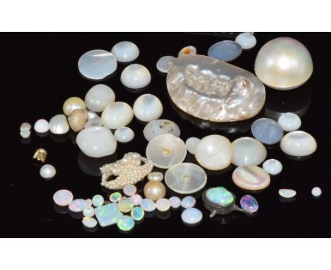 A collection of loose mother of pearl and loose opal cabochons