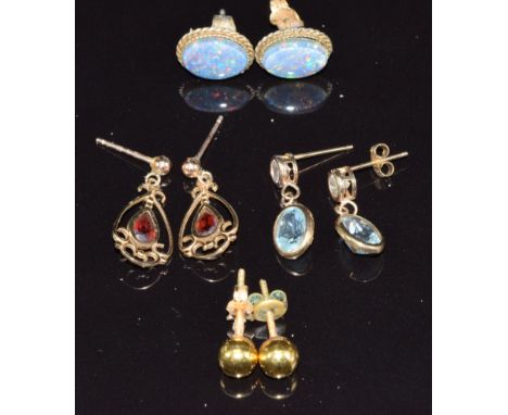 A pair of 9ct gold earrings set with an opal triplet to each, a pair of 18k gold studs, a pair of 9ct gold earrings set with 