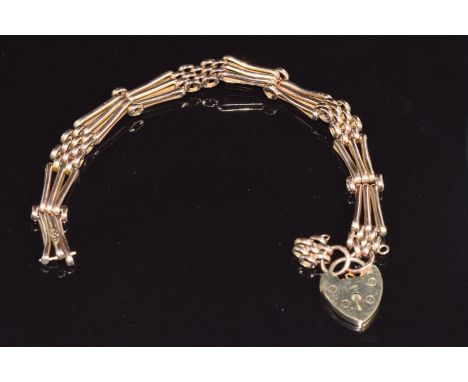 A 9ct rose gold gate bracelet with heart padlock, 10.9g
