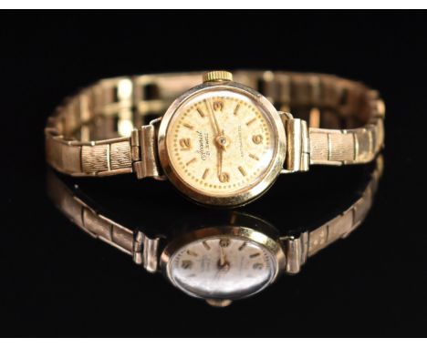 Accurist 9ct gold ladies wristwatch with gold hands, hour markers and Arabic numerals, champagne dial and mechanical movement