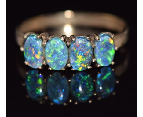 A 9ct gold ring set with four opal triplets, 2.1g, size O