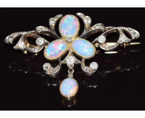 A c1910 gold brooch set with oval opal cabochons and old cut diamonds, 4.9g, 3.7cm long 