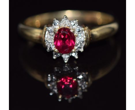 A 9ct gold ring set with a synthetic ruby surrounded by diamonds, 2g, size O