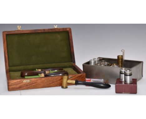 A collection of shotgun tools and accessories including a cased set of three turned mahogany screwdrivers, powder measure, ch