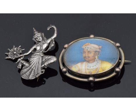 A silver brooch set with an Indian portrait and a Siam silver brooch
