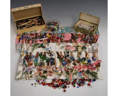 A collection of treen, glass, ceramic and cloisonné lace making bobbins and beads&nbsp;