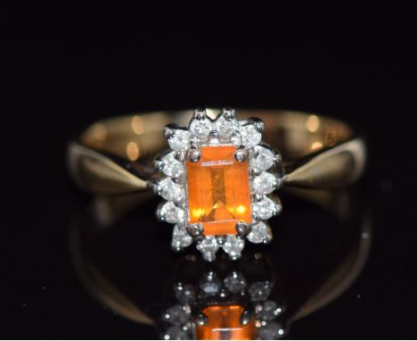 A 9ct gold ring set with an emerald cut fire opal surrounded by diamonds, 3g, size N