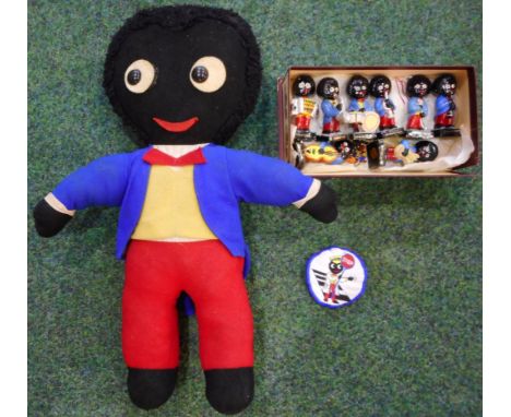 Eight Robertson's Golly bandsmen, two lapel badges and a cloth patch. Also a Golly toy, 44cm high.