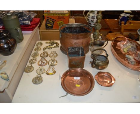 A quantity of various horse brasses; a copper coal scuttle; a brass table lamp base etc.