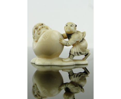 A Japanese carved ivory netsuke,
signed, length 1.6".