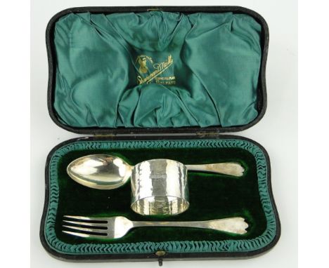 A silver Christening fork, spoon and napkin ring,
Sheffield 1915, original fitted leather case.