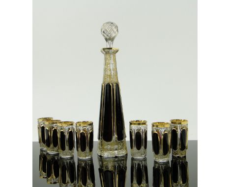 A Bohemian cut-glass liqueur decanter,
height 9.75", with ruby overlay and gilded decoration, and 7 matching tots.