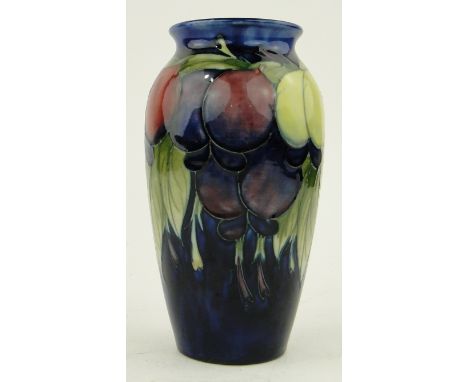 A vintage Moorcroft vase
with design of plums and foliage, signed, height 7".