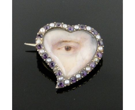 A heart shaped brooch
with central painting of an eye on ivory in amethyst and pearl surround, unmarked gold settings with bl