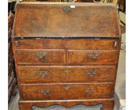 An 18th century crossbanded walnut bureau,
a fall front with stepped fitted interior, 2 short and 2 long drawers under, brack