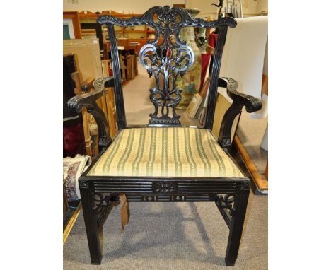 A 19th century Chippendale style carved mahogany open armchair.