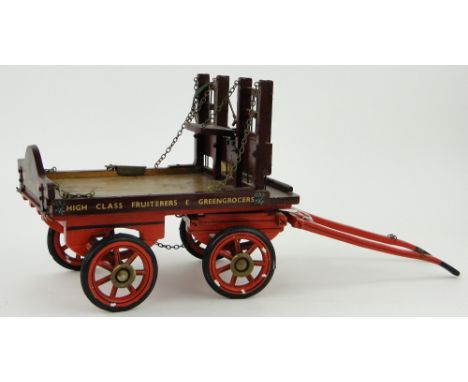 A hand built painted wood greengrocer's cart
for R Parkinson & Sons, length 27" overall.