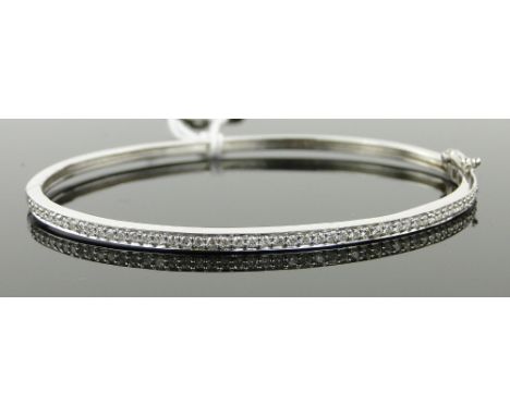 9ct white gold hinged bangle
set with a row of diamonds.