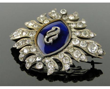 A 19th century paste and enamel starburst brooch,
width 70mm.