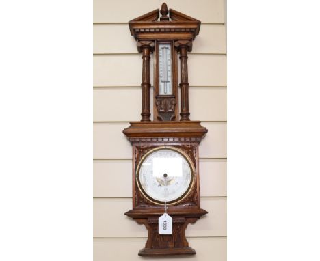 A carved oak-cased aneroid barometer with thermometer, height 66cm 
