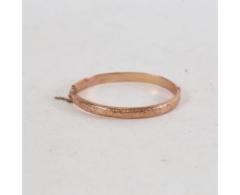 A Victorian 9ct rose gold hinged bangle, engraved floral decoration, hallmarks Birmingham 1898, internal dimensions 6cm x 4.5