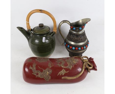 An Oriental ceramic pillow with embossed decoration, length 33cm, a tea kettle, and a stone set  embossed white metal jug 