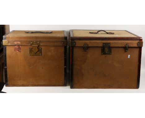 A graduated pair of early 20th century French canvas and metal-bound board travelling trunks, and 2 smaller storage boxes, la