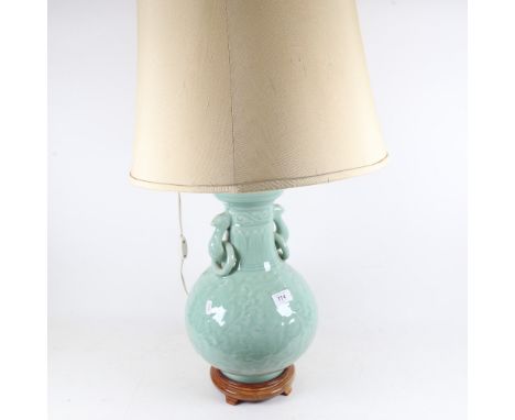 An Oriental celadon style table lamp on wooden plinth, with shade, height 82cm overall 