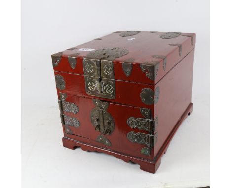 A red lacquered table-top Chinese cabinet, with rising top, 2 drawers under and engraved brass mounts, height 25.5cm 