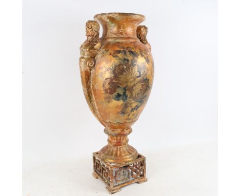 A large gilt ceramic vase, with figural handles and hand painted rose decoration, height 52cm 