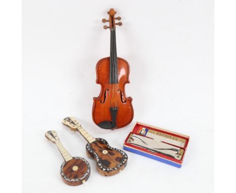 A Hohner Echo harmonica, miniature violin, tortoiseshell and mother-of-pearl inlaid instruments, violin length 23cm (4) 