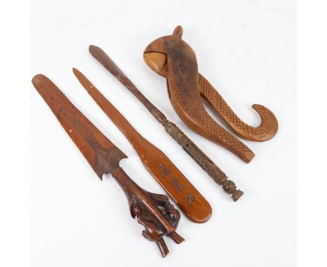 A German Black Forest carved wood letter opener, a carved hardwood nutcracker etc (4) 