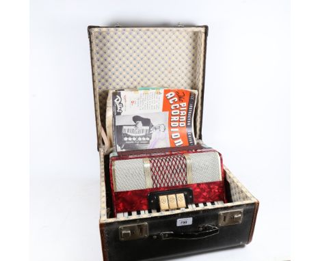 A Vintage piano accordion in carrying case, with instruction books 