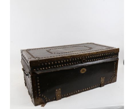 An early 20th century brass-studded leather-bound wood travelling trunk, width 62cm, height 26cm, depth 33cm 