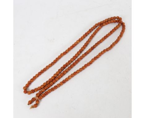 A long single strand of polished coral prayer beads, 47.1g .&nbsp;The necklace is in good condition with just some light wear