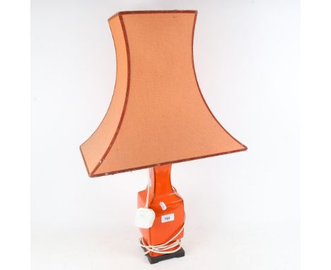 A retro orange glazed ceramic table lamp, with shade, height 67.5cm 