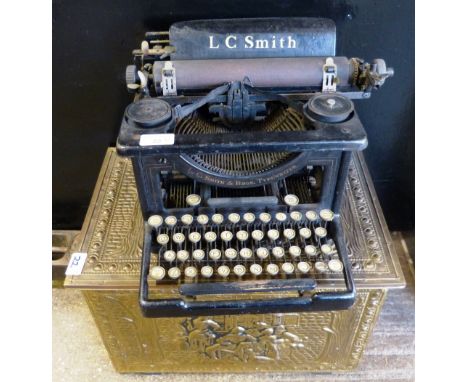 An L. C. Smith manual typewriter, brass bound box including brass figure of a horse jumping a gate (3)