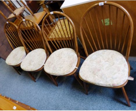 Ercol - a set of four beech and elm stick-back dining chairs with original pads, please note the pads do not conform to curre