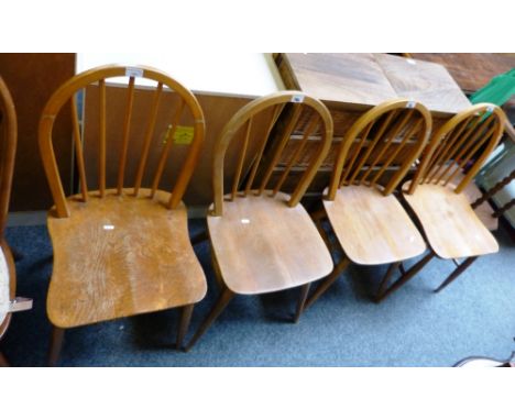 Ercol - a set of four beech and elm stick-back kitchen chairs 