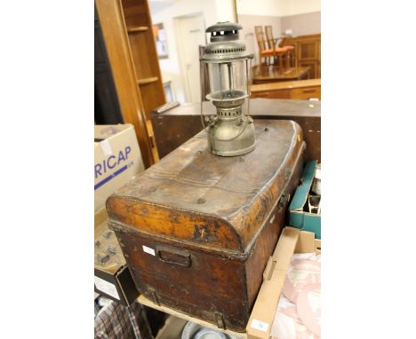 A TIN TRUNK TOGETHER WITH A PARAFFIN LAMP