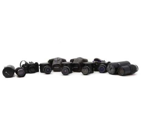 A collection of Olympus cameras and equipment to inlcude two OM-4s one without lens, a OM-4 Ti, OM-2, and a series of lens, t